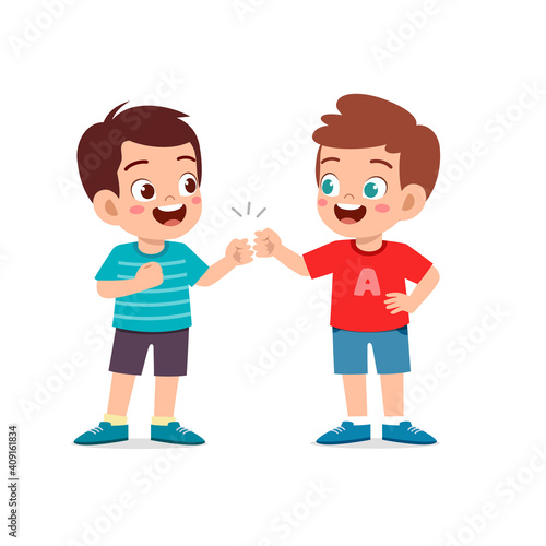 cute little kid boy do bro fist with his friend