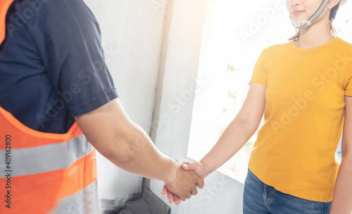 Young asian shake hand with foreman engineering home inspection building house Walk home inspection with looking and pointing construction for check building home on job site to customers