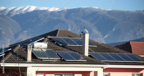 solar panels on the roof of a house alternative energy green fir tree photo