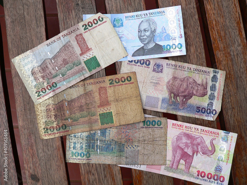 Top view of Tanzanian shilling banknotes on a wooden surface