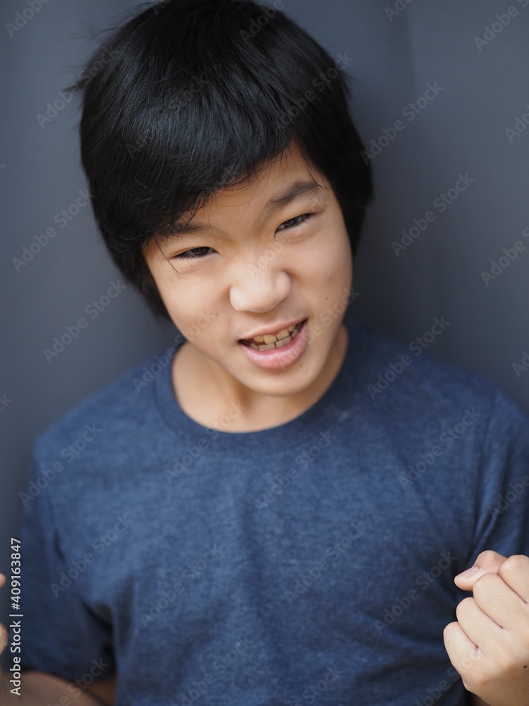 Funny portrait of 11 years old asian boy with dark blue t shirt Funny portrait of 11 years old asian boy with dark blue t shirt