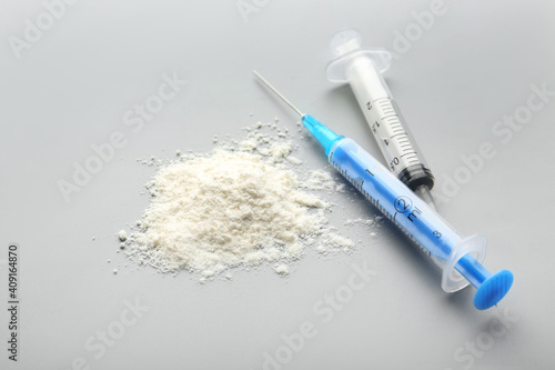 Cocaine with syringes on gr...