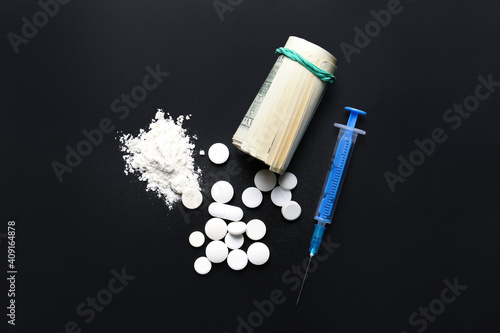 Syringe, drugs and money on...