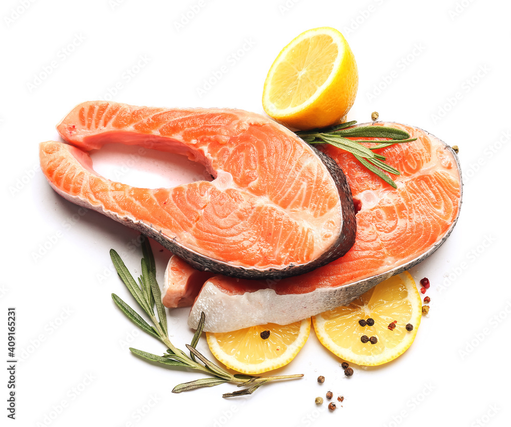 Raw salmon steaks and lemon on white background Raw salmon steaks and lemon on white background