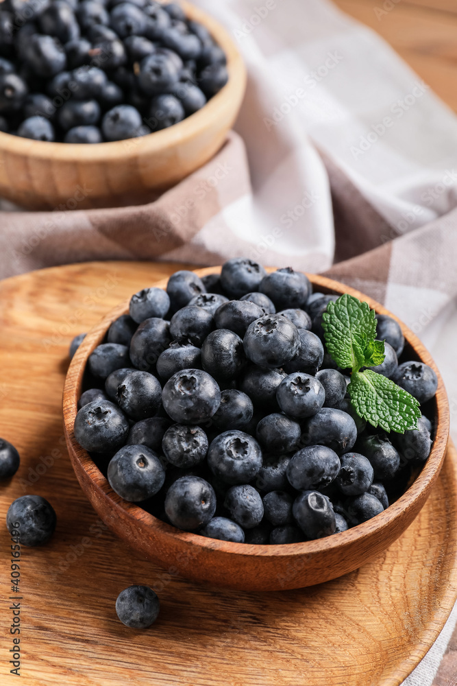 Bowls with tasty ripe blueberry on table Bowls with tasty ripe blueberry on table