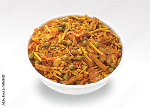 Indian Namkeen Snacks served in ceramic bowl & plate or Indian traditional Namkeen Food Mixture or Navratna Mix Namkeen Also Know as Nimco, Namkin, Mixture ,chiwda or Nimko