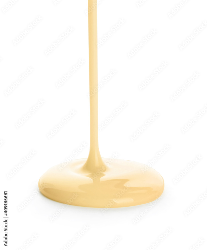 Pouring condensed milk on white background Pouring condensed milk on white background