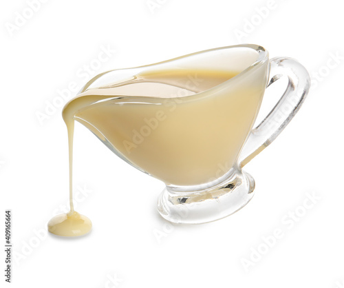 Gravy-boat with sweet condensed milk on white background