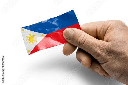 Hand holding a card with a national flag the Philippines