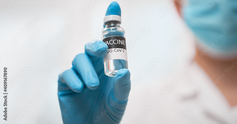 Doctor holding vaccine COVID-19. Medicine vaccination concept Doctor holding vaccine COVID-19. Medicine vaccination concept