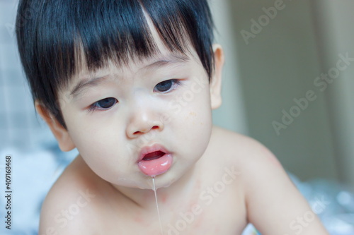 Tablou pe pânză Asian baby drooling isolated on white background