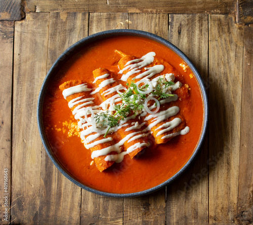 Tradicionales Enchiladas en salsa roja Mexicanas photo