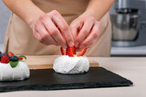 Pastry chef prepares berry dessert. Strawberry cake decorating process