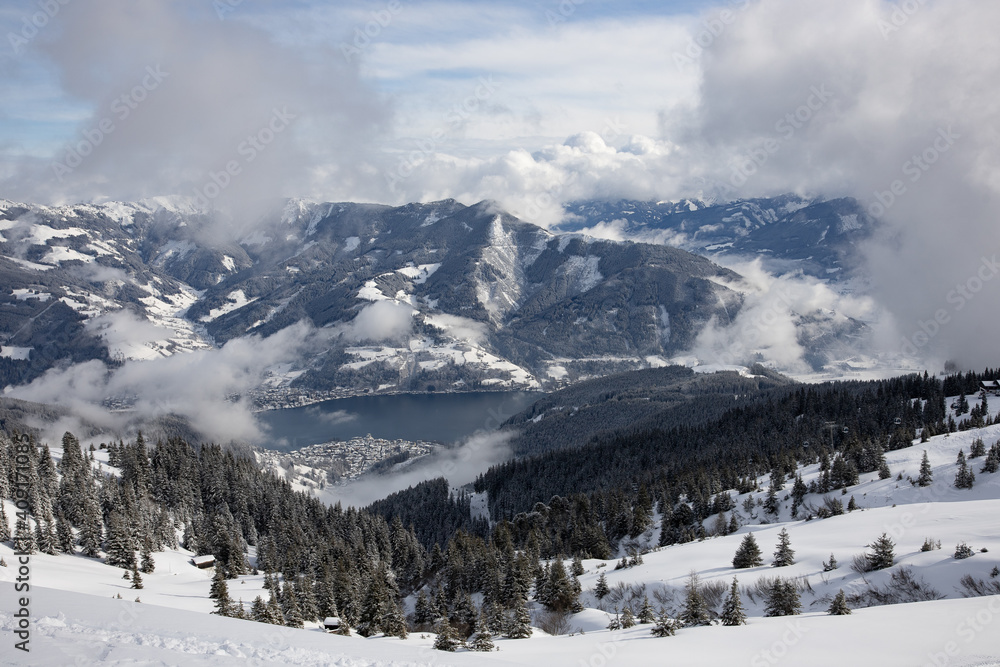 View of Zell am See (Salzburg, Austria) from the ski slopes of Schmittenhöhe, with dramatic clouds and lots of snow.