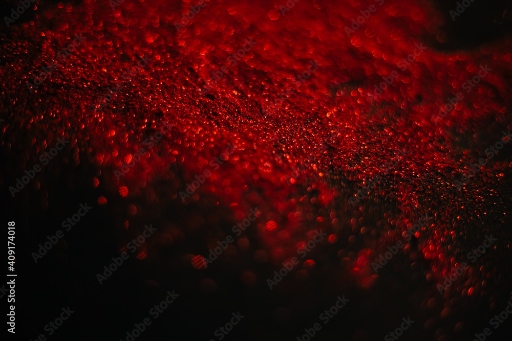 Red sand from sequins. Scattered sparkles on a black background. Space texture. Stars Red sand from sequins. Scattered sparkles on a black background. Space texture. Stars