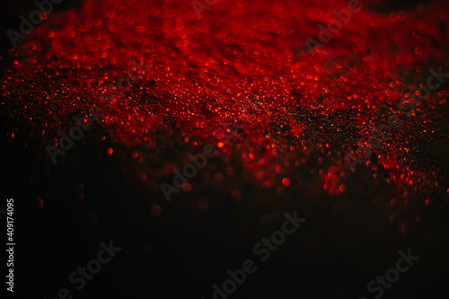 Wallpaper Mural Red sand from sequins. Scattered sparkles on a black background. Space texture. Stars Torontodigital.ca