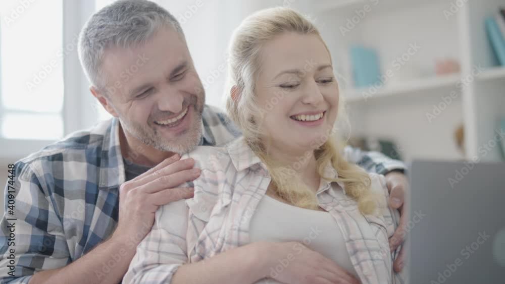 Cheerful married couple communicating with relatives online, internet connection Cheerful married couple communicating with relatives online, internet connection