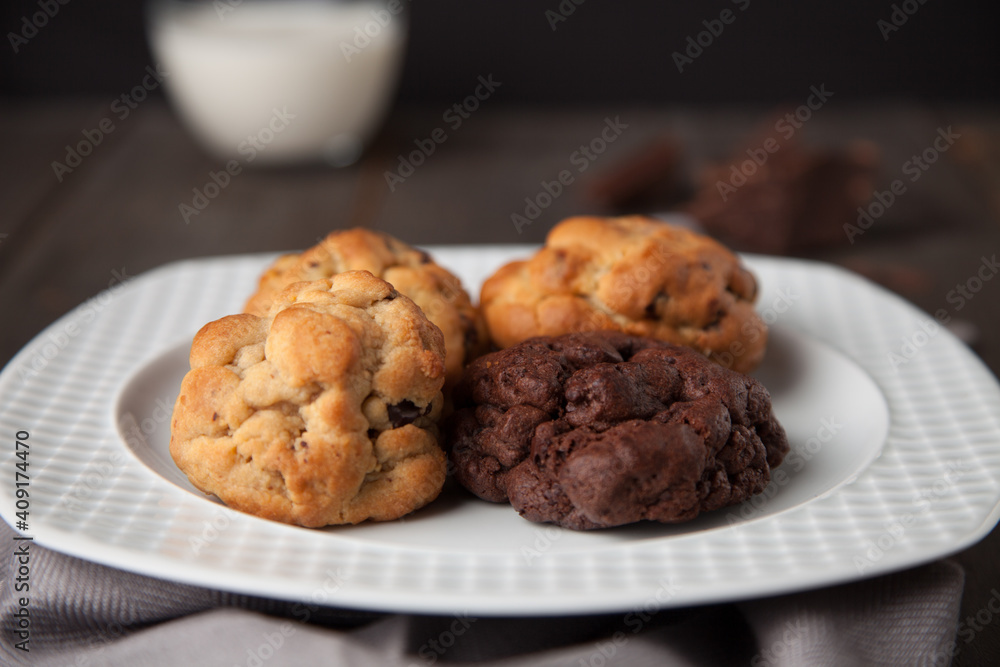 Cookies on a wooden table with a glass of milk Cookies on a wooden table with a glass of milk