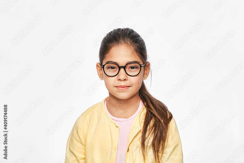 Beautiful asian little girl in stylish glasses on gray background
