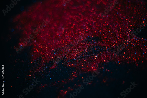 Wallpaper Mural Red sand from sequins. Scattered sparkles on a black background. Space texture. Stars Torontodigital.ca