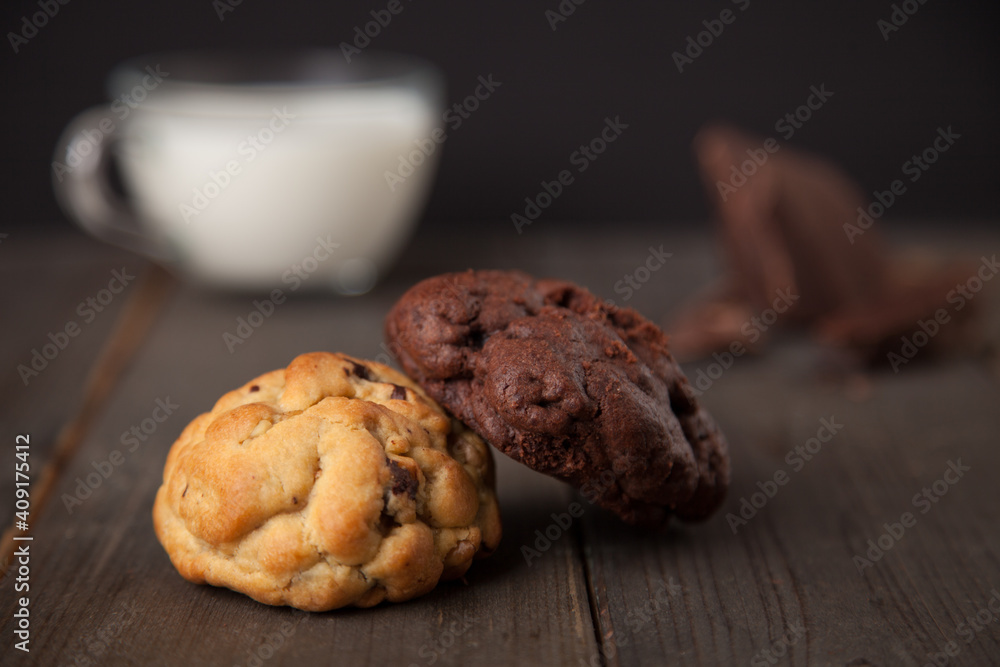 Cookies on a wooden table with a glass of milk Cookies on a wooden table with a glass of milk