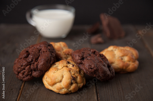 Cookies on a wooden table with a glass of milk