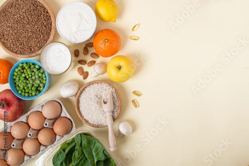 a set of useful foods and vitamins on a light yellow background.