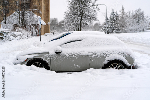 Vehicles covered with snow in the winter blizzard