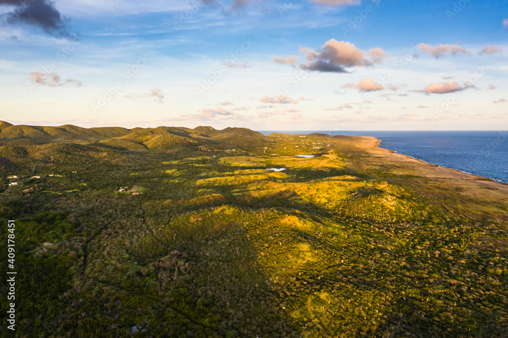 Aerial view above scenery of Curacao, Caribbean with ocean, coast, hills, lake