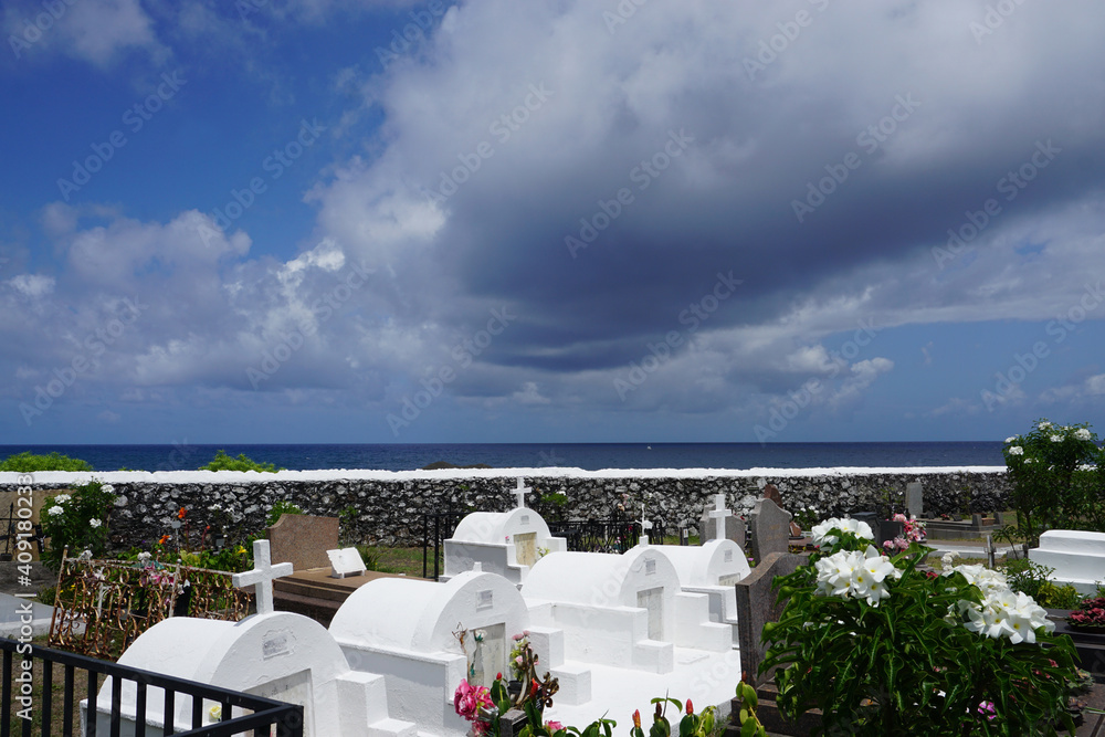 stormy sky above the ocean and typical cemetery in the tropical island of La Réunion, France
