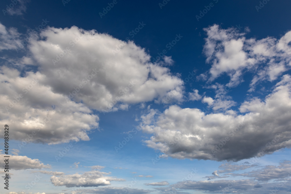 Fototapeta premium High white cirrus clouds with cirro-stratus in a light blue sky, sometimes called chair tails, indicate nice weather, but stormy changes come within a few days. White clouds in a blue sky. 