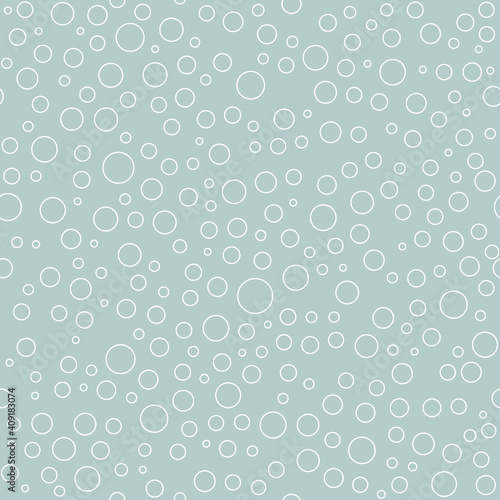 Seamless background with random round white elements. Abstract ornament. Dotted abstract pattern