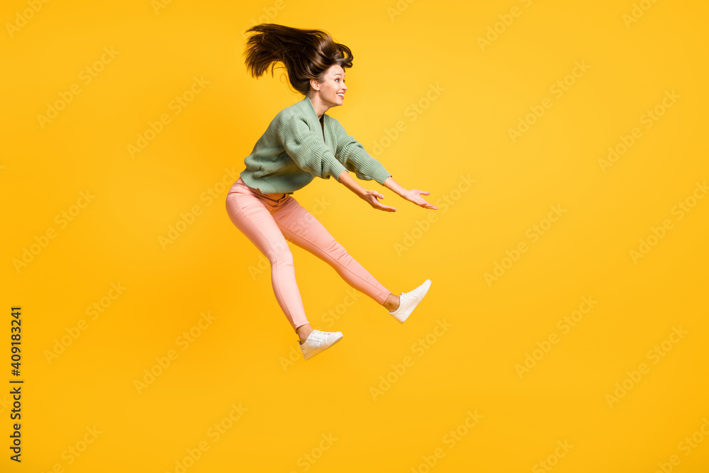 Full size profile side photo of young happy positive crazy smiling girl look copyspace jumping isolated on yellow color background