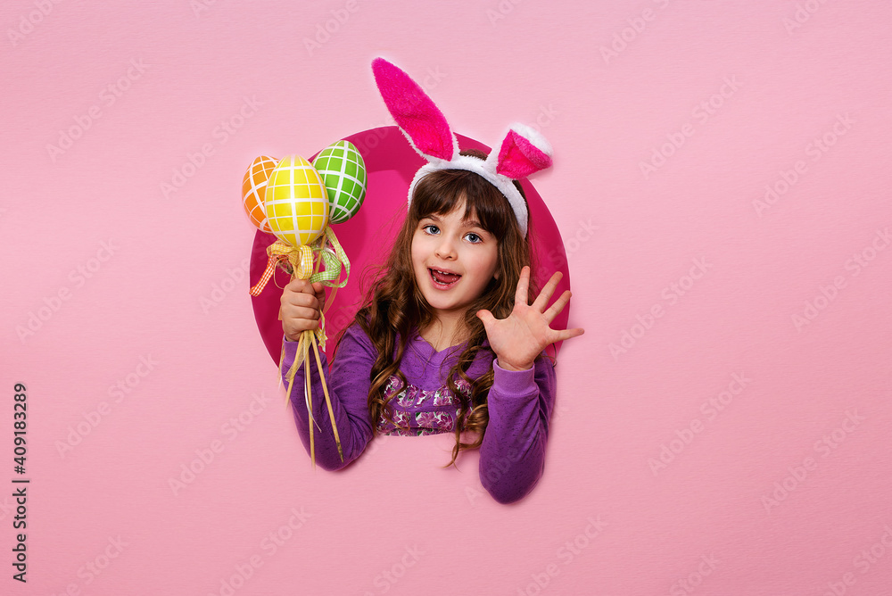 Happy girl with Easter painted eggs