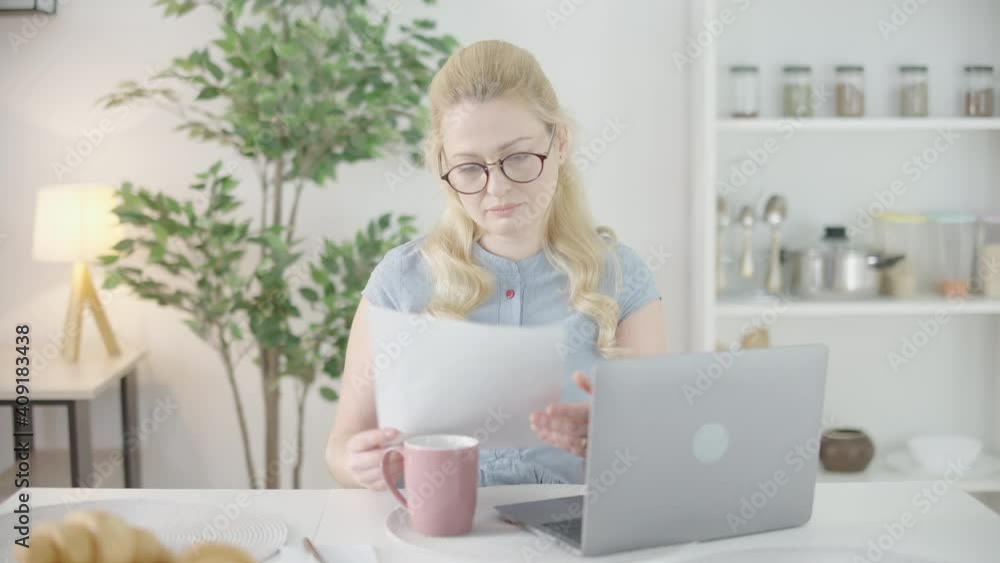 Happy female freelancer in eyeglasses working on online project at home, job Happy female freelancer in eyeglasses working on online project at home, job