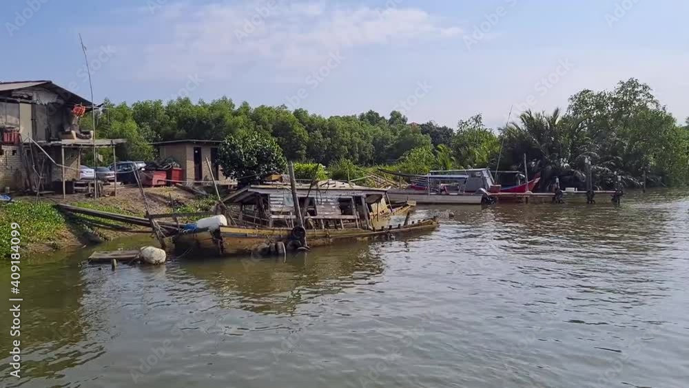Abandoned Fishing Boat By The Ocean Bay With A Small Shed On Land - Pan Left To Right Abandoned Fishing Boat By The Ocean Bay With A Small Shed On Land - Pan Left To Right