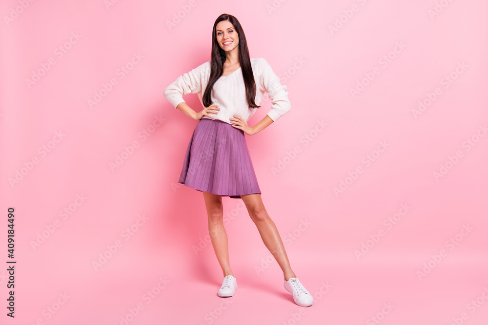 Full size photo of young beautiful happy smiling cheerful confident girl with long perfect hair isolated on pink color background Full size photo of young beautiful happy smiling cheerful confident girl with long perfect hair isolated on pink color background