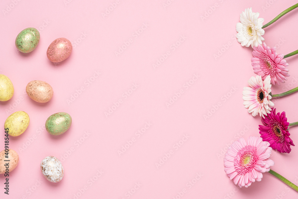 Happy Easter holiday pink background. Flat lay colourful decorated eggs and flowers. Design pastel tone
