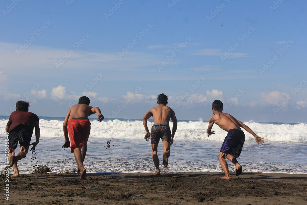 people running on the beach on January 24th 2019 in Indonesia people running on the beach on January 24th 2019 in Indonesia