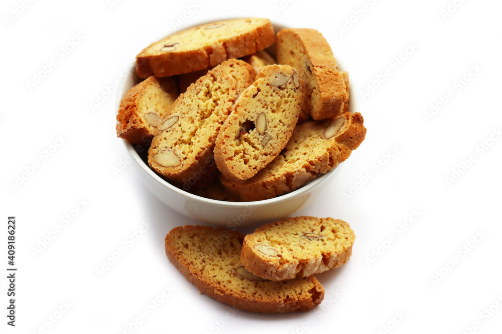 Traditional Italian Cantucci or Cantuccini cookies with almonds in a bowl isolated on white background