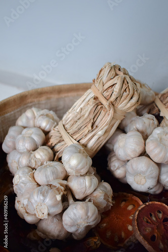 Garlic in organic bag on the table in kitchen room.