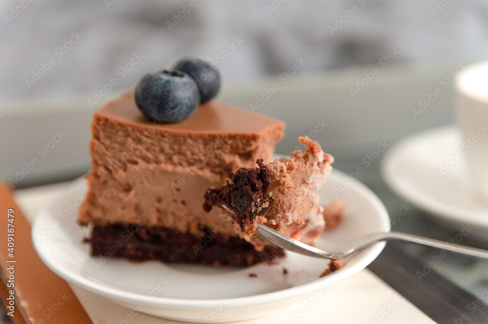 Piece of chocolate cheese cake with morning coffee on the bed Piece of chocolate cheese cake with morning coffee on the bed