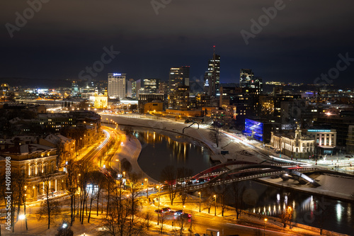 Vilnius, capital of Lithuania, beautiful scenic aerial panorama of modern business financial district architecture buildings with river and bridge in winter