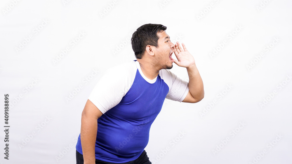 Portrait of funny young Asian man shouting and yelling Portrait of funny young Asian man shouting and yelling