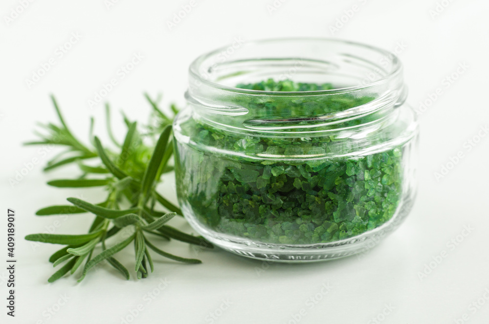 Glass jar with green rosemary bath salts (foot soak). Glass jar with green rosemary bath salts (foot soak).