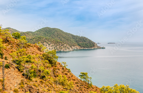 Rocky coastline of Turkish Riviera with pine trees and Mediterranean Sea