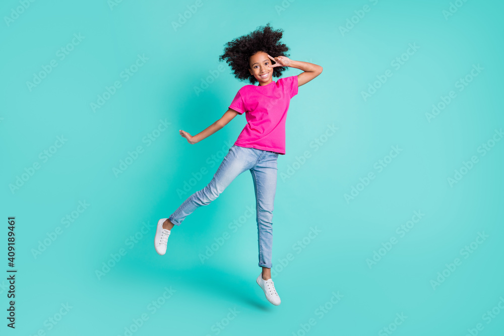 Full size photo of young pretty sweet charming lovely happy girl jump show v-sign on eye isolated on teal color background