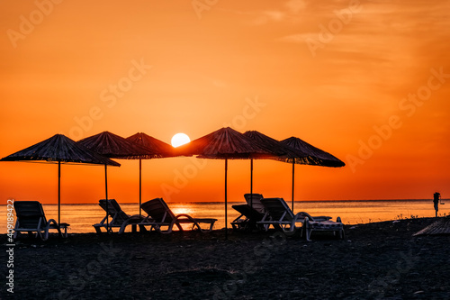 Beach umbrellas at sunrise © amelie