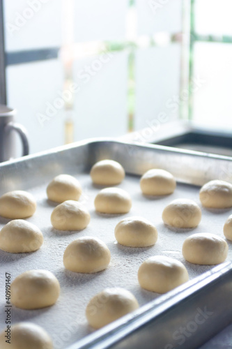 pattern of donnut dough on bake sheet with white flour