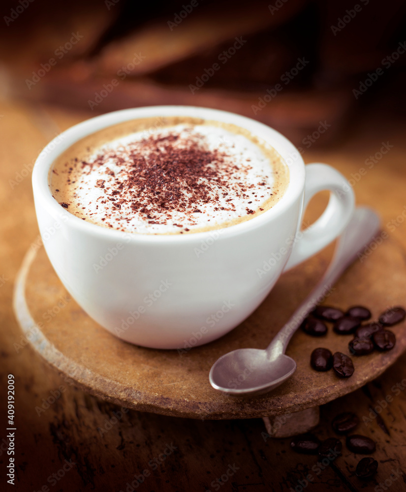 Obraz premium white cup with teaspoon on on wooden stand